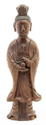 A Carved Wood Figure of a Standing Guanyin. Height 12 1/2 inches.