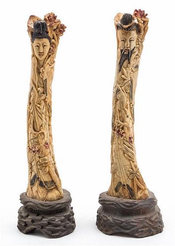 A Pair of Carved Bone Figures Height 13 inches.