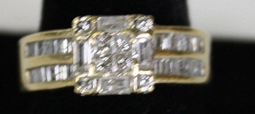 14k y.g. ladies ring having 8 small square cut diamonds and 4 baguette cut diamond. Each side has 2
