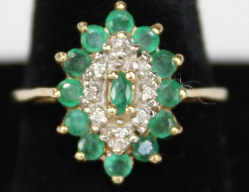10k y.g. ladies ring having marquis form setting with center small emerald having 8 small round cut
