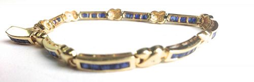 14k y.g. bracelet having 9 sections each with 5 channel set small (.04ct) sapphires. 7¼". 10 grams t