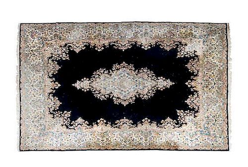 A Kerman Wool Rug, 9 feet 10 inches x 13 feet 9 inches.
