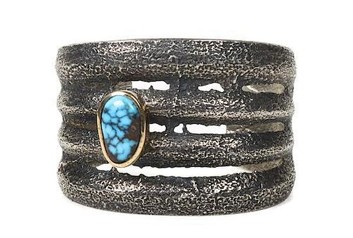 A Hopi Silver, Gold and Turquoise Tufa-Cast Bracelet, Charles Loloma, Length 6 x opening 1 1/8 x width 1 7/8 inches.
