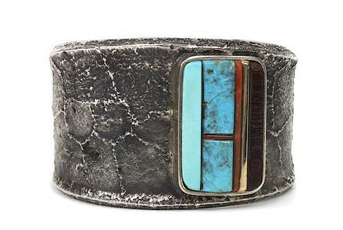 A Hopi Silver Tufa-Cast Bracelet, Charles Loloma, Length 6 x opening 7/8 x width 1 5/8 inches.