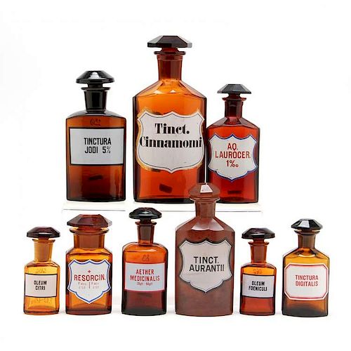 Group of Nine Similar Amber Glass Apothecary Bottles 