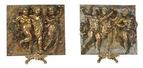Pair of Continental Gilt Bronze High Relief Plaques, early 20th c., depicting a procession of frolicking putti, together with two modern brass stands,