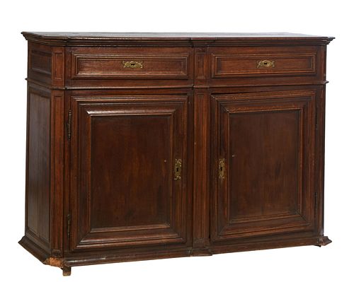 French Provincial Carved Oak Louis XIV Style Sideboard, 19th c., the canted corner three board top over two frieze drawers above double cupboard doors