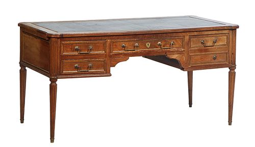 French Provincial Louis XVI Style Carved Walnut Desk, early 20th c., the gilt tooled black leather cookie corner ogee edge top over a center drawer fl