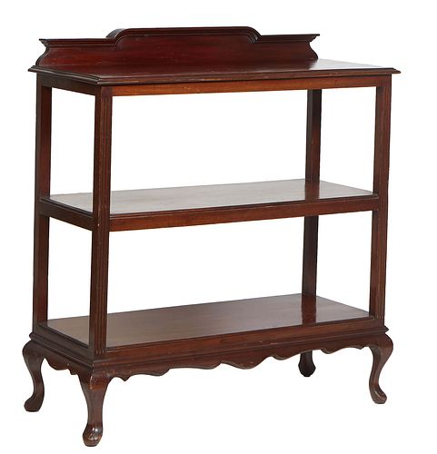 English Queen Anne Style Carved Mahogany Serving Trolley, early 20th c., the arched back splash over a stepped shelf on reeded square supports to a li