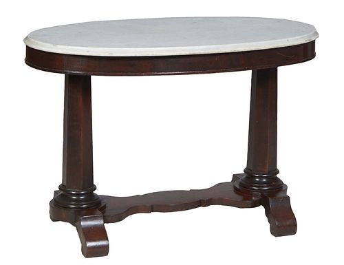 American Classical Carved Mahogany Oval Marble Top Center Table, 19th c., the ogee edge figured white marble over a wide skirt, on tapered hexagonal t