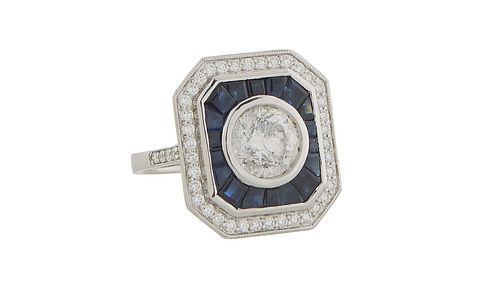 Lady's 18K White Gold Dinner Ring, the octagonal top with a central 2.06 ct. round diamond atop a border of blue sapphires within an outer border of r