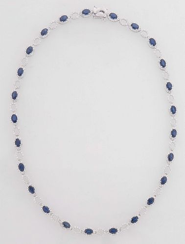 14K White Gold Link Necklace, each with a graduated oval blue sapphire atop a border of round diamonds, joined by twenty-five pierced oval diamond mou
