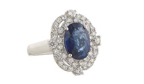 Lady's Platinum Dinner Ring, with a 3.66 carat oval blue sapphire atop a pierced border mounted with forty-two small round diamonds, total diamond wt.