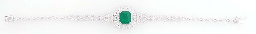 Lady's 14K White Gold Link Bracelet, with a central 5.39 ct. emerald atop a border of tiny round diamonds within a pierced octagonal diamond mounted b