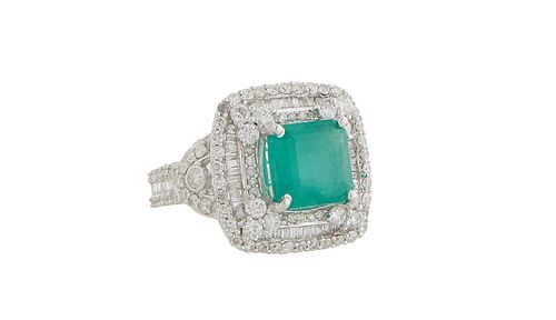 Lady's 14K White Gold Dinner Ring, with a 4.56 ct. emerald atop a border of tiny round diamonds, over a concentric graduated double border of baguette