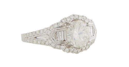 Lady's 18K White Gold Dinner Ring, with a round 1.54 ct. center diamond, flanked on the top and bottom with round diamonds, and graduated baguette dia