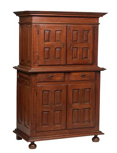 French Provincial Louis XIII Style Carved Walnut Buffet a Deux Corps, 19 th c., the stepped crown over double cupboard doors with fielded geometric re