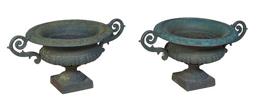 Pair of American Cast Iron Garden Planters, 19th c., of campana form with scrolled handles and lobed relief sides, to a socle support, on a square bas