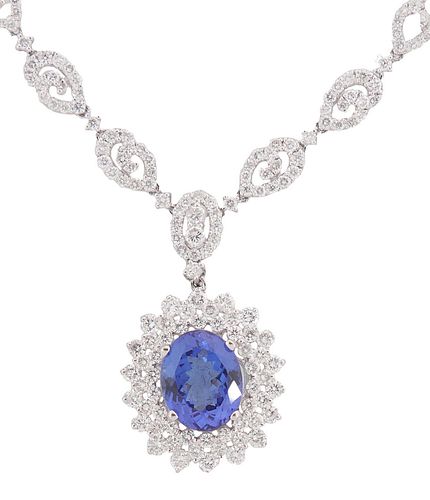 18K White Gold Link Necklace, with a central pendant with a 5.81 ct. oval tanzanite atop a double concentric graduated border of round diamonds, suspe