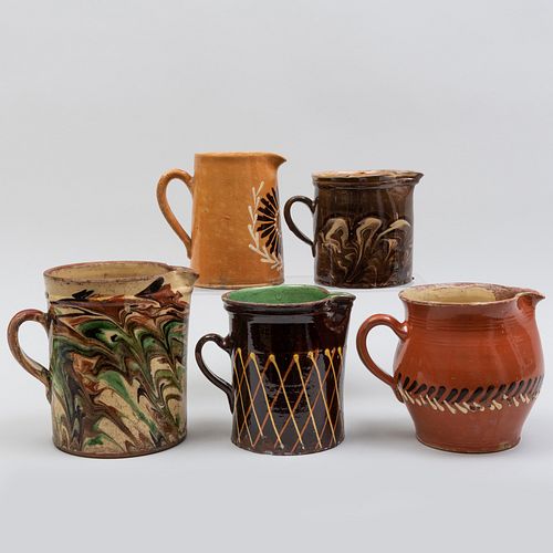 Group of Five Slip Decorated Pitchers
