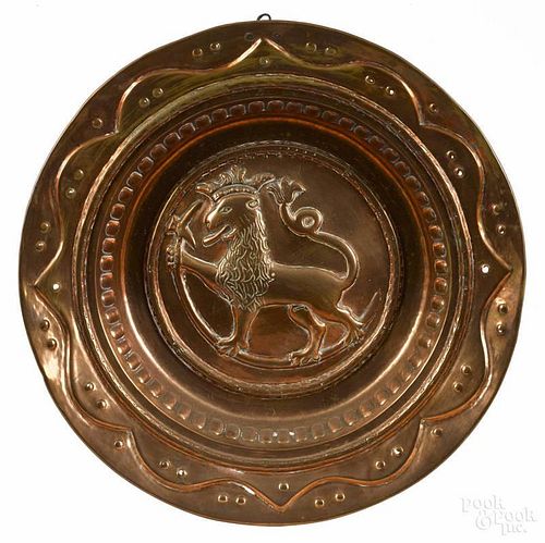 Continental embossed copper alms dish, 18th c., with rampant lion, 20 1/2'' dia.