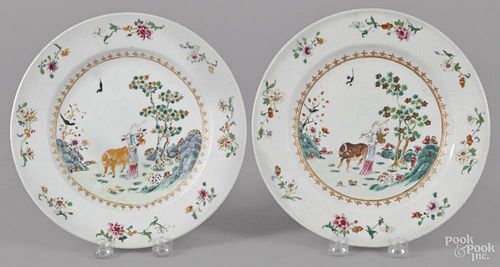 Pair of Chinese famille rose porcelain plates, late 18th c., decorated with a woman with an ox