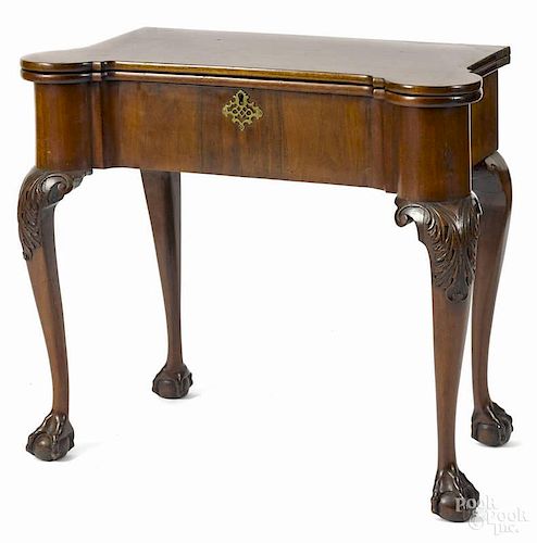 George III mahogany games table, ca. 1760, with a concertina top and carved cabriole legs