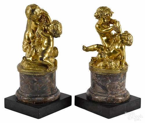 Pair of French gilt bronze putti groups, late 19th c., set on marble bases, 13'' h.