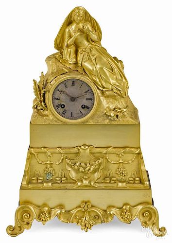 French gilt bronze mantel clock, late 19th c., with a figure of a woman with a compact, 16 1/4'' h.
