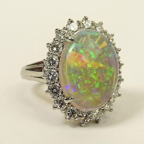 Lady's Oval Cut White Opal, Approx. 1.0 Carat Round Brilliant Cut Diamond and Platinum Ring.