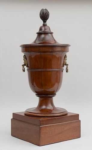 GEORGE III BRASS-MOUNTED CARVED MAHOGANY URN-FORM CELLARETTE AND COVER