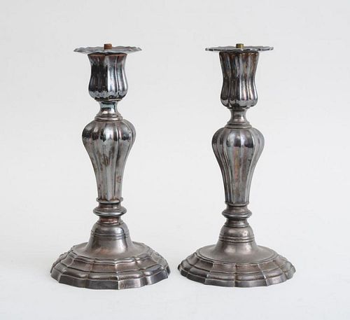 ASSEMBLED PAIR OF EARLY LOUIS XV STYLE SILVERED METAL CANDLESTICKS