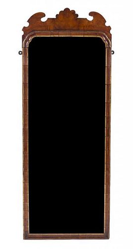 A Georgian Walnut and Parcel Gilt Mirror Height 42 1/2 inches.