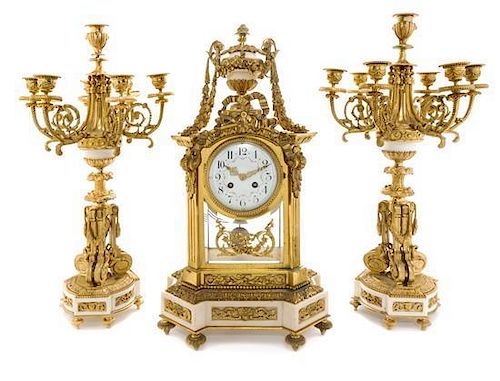 A Louis XVI Style Gilt Bronze and Marble Clock Garniture Height of candelabra 22 3/4 inches.