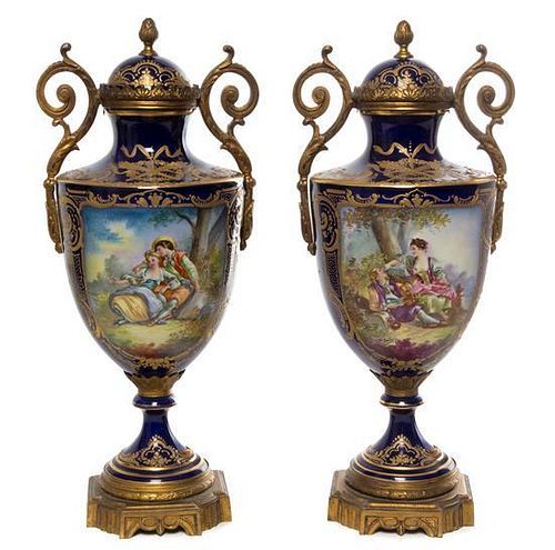 * A Pair of Sevres Style Gilt Bronze Mounted Porcelain Urns Height 15 3/8 inches.