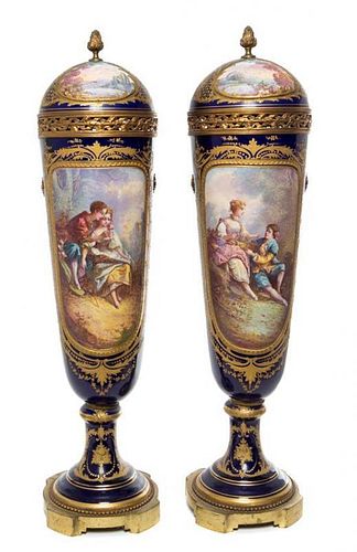 * A Pair of Sevres Porcelain Lidded Urns Height 28 inches.