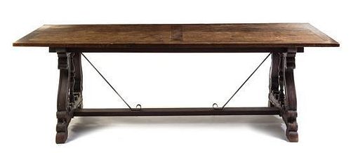 A Spanish Baroque Walnut and Iron Trestle Table Height 29 1/2 x width 35 1/2 x depth 94 3/4 inches.