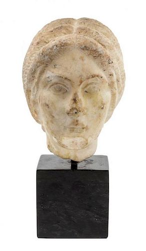 A Roman Marble Portrait Head of a Woman Height 9 1/4 inches.