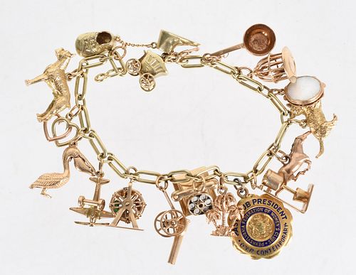 A 14k Gold Charm Bracelet with 17 Charms