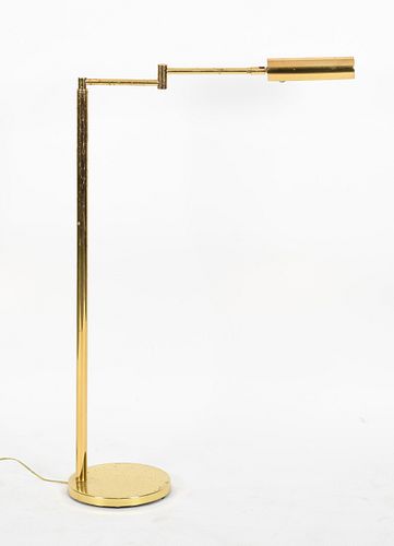 A brass adjustable reading floor lamp