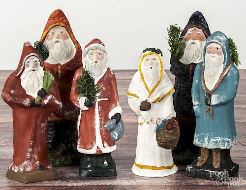 Six contemporary chalkware belsnickle Santa Claus figures, four initialed HD, tallest - 10 3/4''.