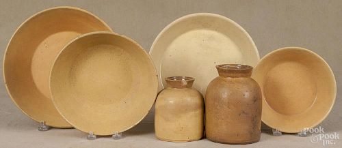 Four yelloware shallow bowls, 19th c., the largest with heart feet, 11 1/2'' dia.