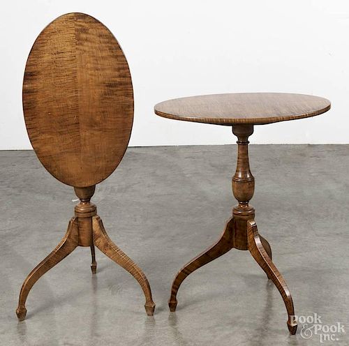 Pair of cabinet made tiger maple candlestands with tilting oval tops, 26 1/2'' h., 22 1/4'' w.