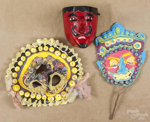 Seven outsider art masks, two carved and painted, three papier-mâché and two foam