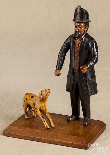 Contemporary carved and painted fireman and his dog, 10'' h.