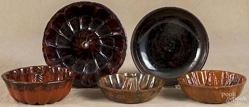Four redware turk's head molds, 19th c., together with a shallow bowl, largest - 10 1/4'' dia.