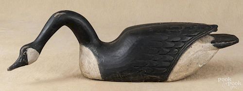 Carved and painted swimming Canada goose decoy, mid 20th c., with carved wing details, 34 1/2'' l.