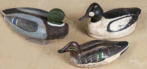 Three carved and painted duck decoys, mid 20th c., to include a balsa body mallard, a goldeneye