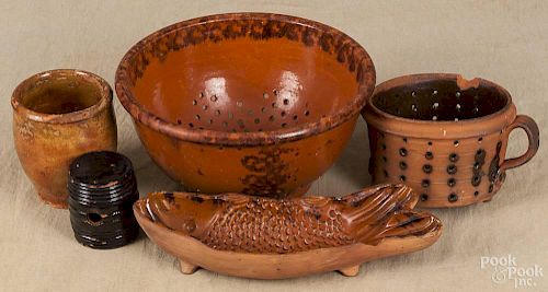 Six pieces of redware, 19th c., to include two colanders, a jug, a crock, a fish mold, and a barrel