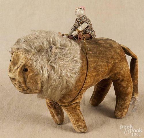 Stuffed lion toy, early 20th c., with carved and painted jointed clown rider, 7'' h., 11'' l.